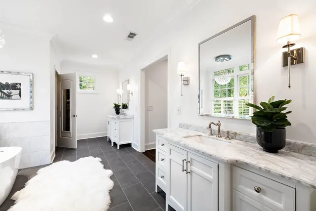 a bathroom with a double vanity sink and a mirror