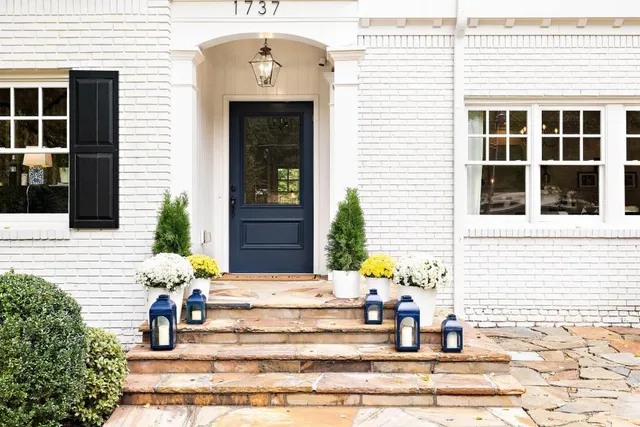 a front view of a house with potted plants