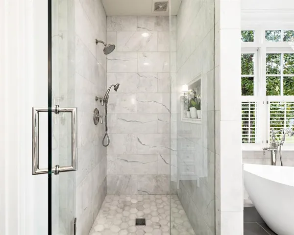 a bedroom with a bed lamps and wooden floor