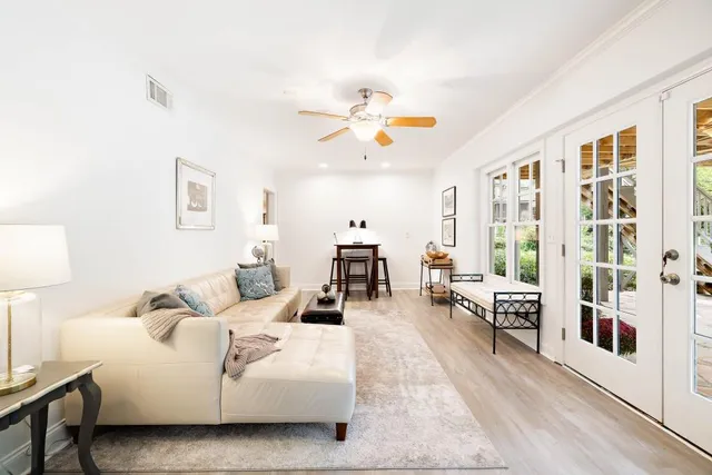 a front view of a house with a yard and balcony