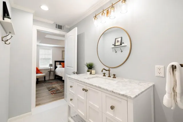 a view of a house with swimming pool and a chairs and tables in the patio