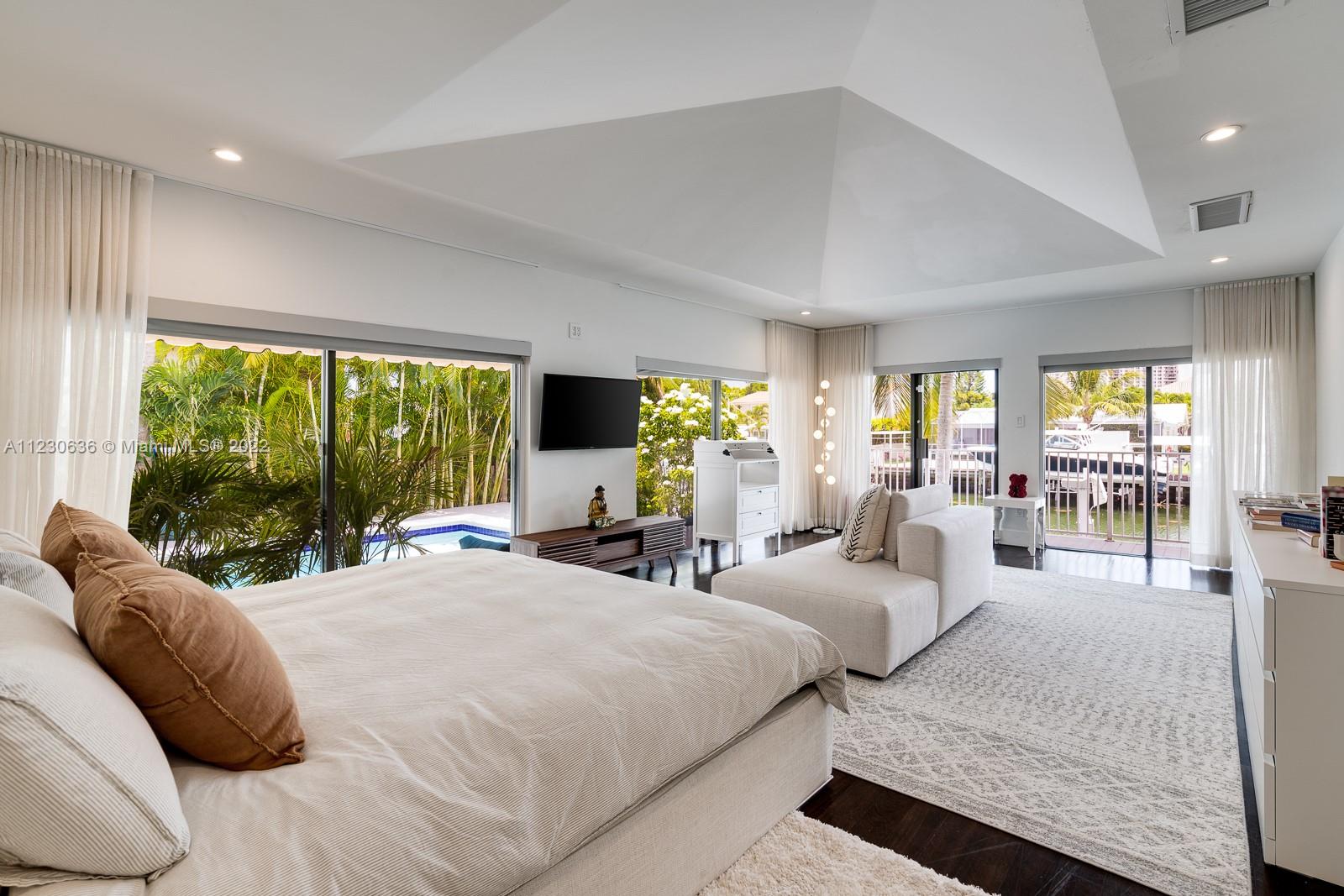 1922 Northeast 119th Road North Miami, FL 33181 - Photo 15 of 42 a large bedroom with a large bed and a large window