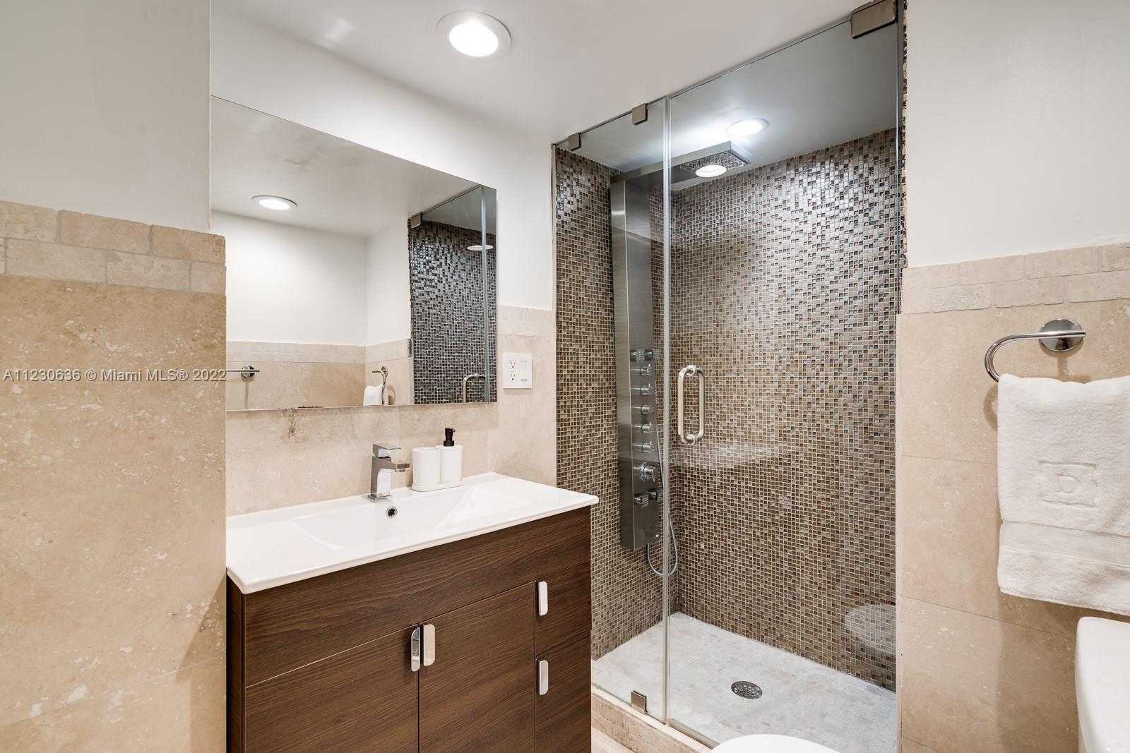 1922 Northeast 119th Road North Miami, FL 33181 - Photo 25 of 42 a bathroom with a sink shower and a mirror