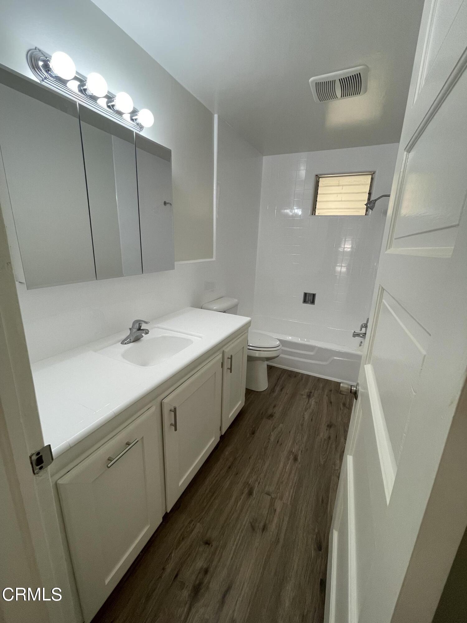 218 Wolff Street Oxnard, CA 93033 - Photo 11 of 12 a bathroom with a double vanity sink and mirror