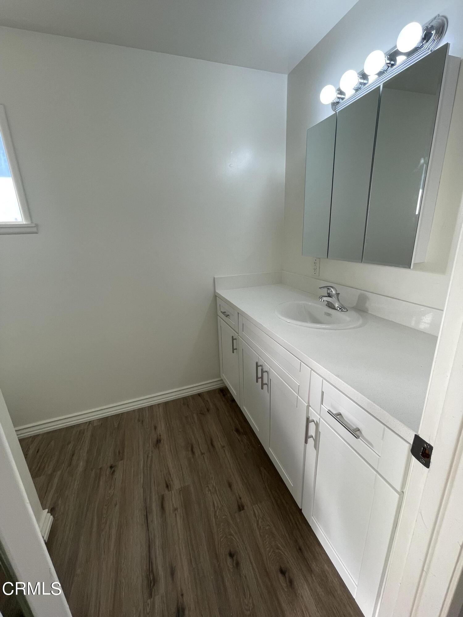 218 Wolff Street Oxnard, CA 93033 - Photo 12 of 12 a bathroom with a sink and a mirror