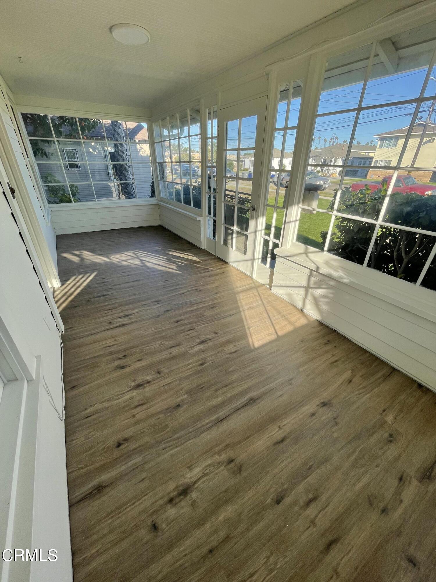 218 Wolff Street Oxnard, CA 93033 - Photo 6 of 12 a view of an empty room with wooden floor and windows