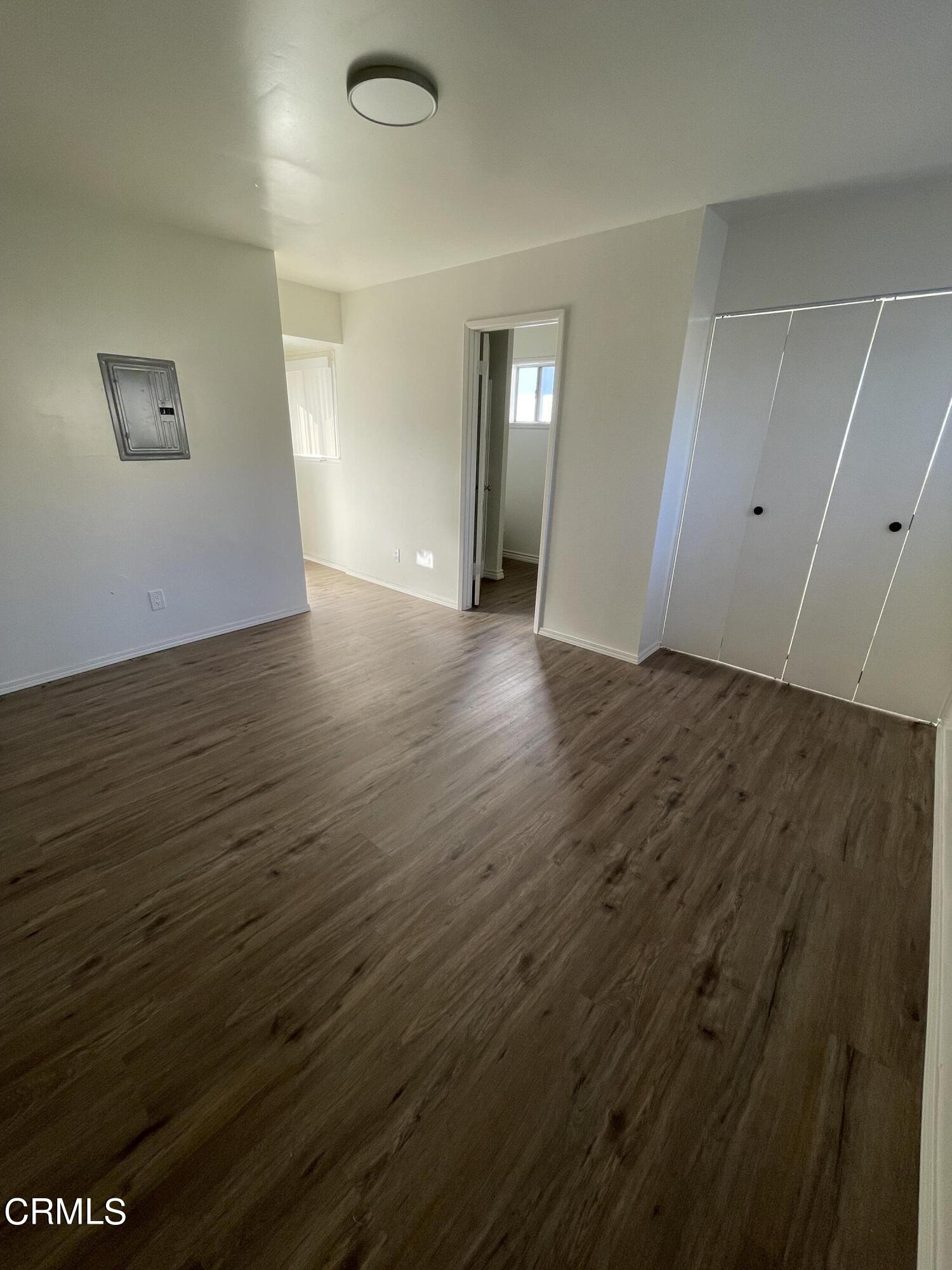 218 Wolff Street Oxnard, CA 93033 - Photo 10 of 12 an empty room with wooden floor and closet