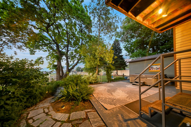 374 West Lakeview Road Lindon, UT 84042 - Photo 3 of 44 Outdoor patio with stone pathway, mature trees, built-in hot tub, and exterior lighting