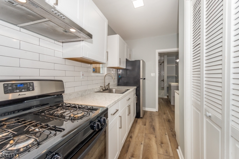 a kitchen with a stove and a refrigerator
