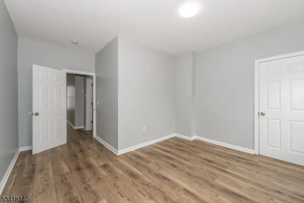 a view of a room with wooden floor and closet