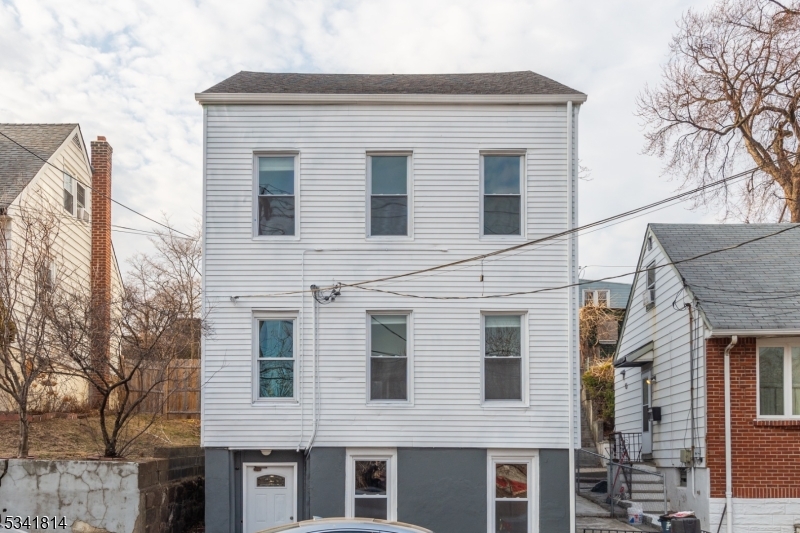 93 Front Street, Unit 2 Paterson, NJ 07522 - Photo 12 of 12 a front view of a house with yard