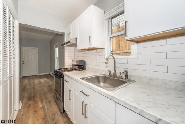 a kitchen with a sink and cabinets