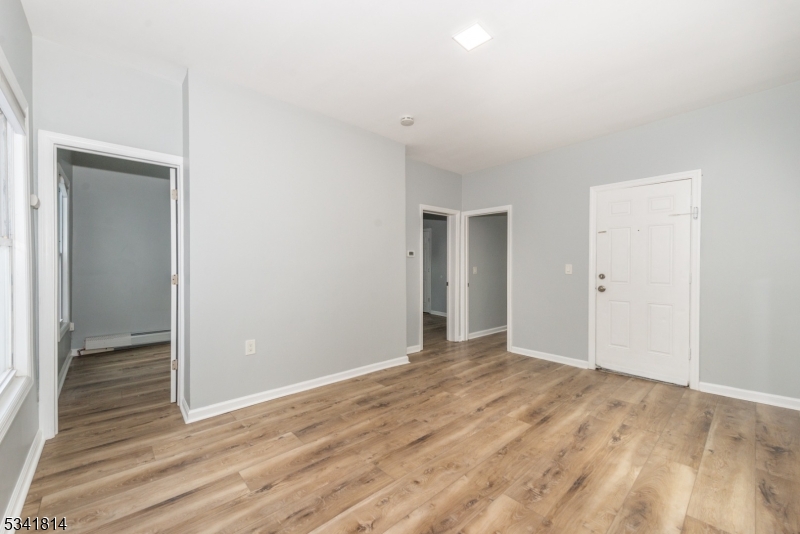 93 Front Street, Unit 2 Paterson, NJ 07522 - Photo 3 of 12 a view of an empty room with wooden floor