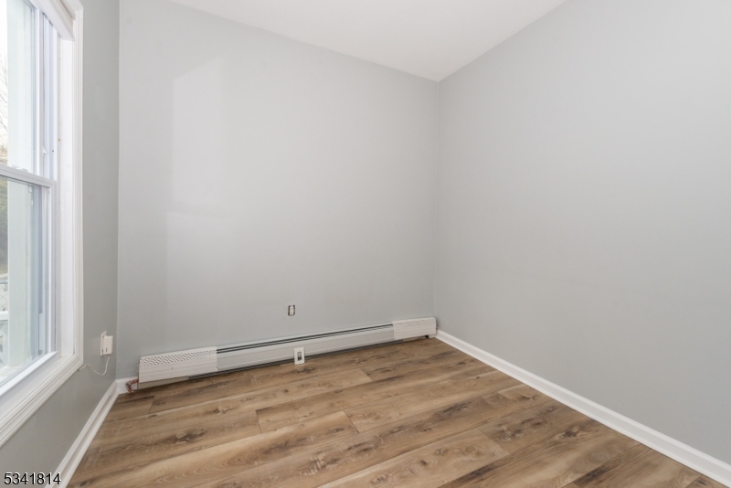 93 Front Street, Unit 2 Paterson, NJ 07522 - Photo 7 of 12 a view of a room with wooden floor and window
