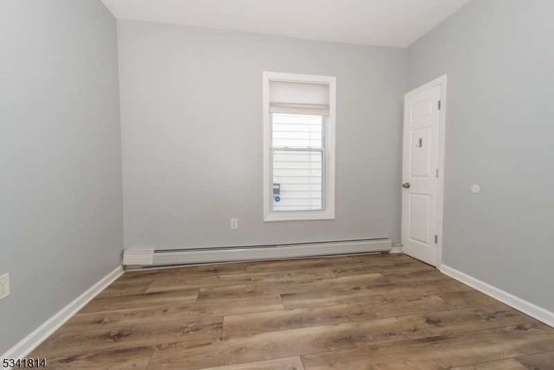93 Front Street, Unit 2 Paterson, NJ 07522 - Photo 9 of 12 wooden floor in an empty room