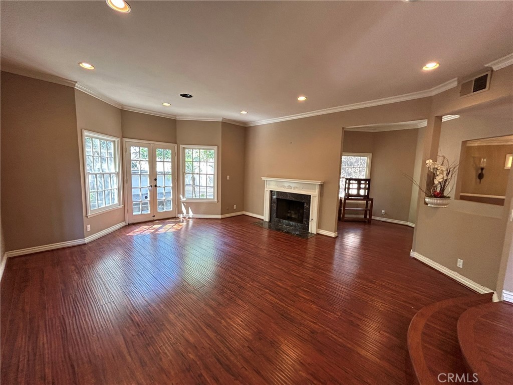 300 South Timken Road Anaheim, CA 92808 - Photo 8 of 40 an empty room with wooden floor and a fireplace