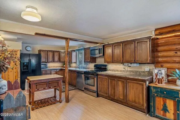 a kitchen with a sink cabinets and wooden floor