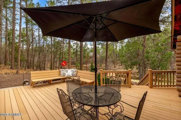 a patio with water view fountain with wooden floor and outdoor seating