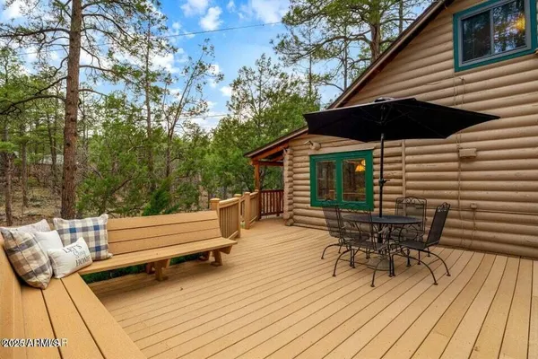 a roof deck with a table and chairs