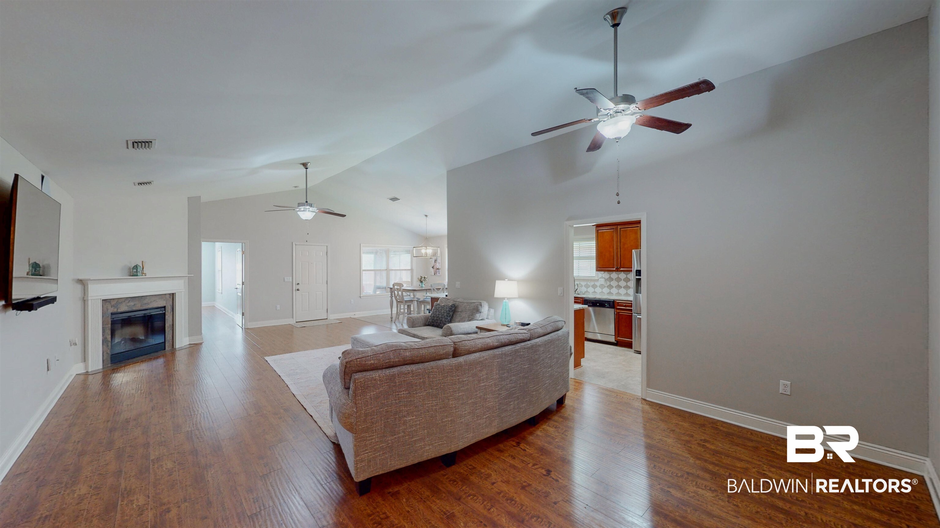 1704 Arcadia Drive Foley, AL 36535 - Photo 10 of 52 Living area featuring ceiling fan, lofted ceiling, wood finished floors, and a premium fireplace
