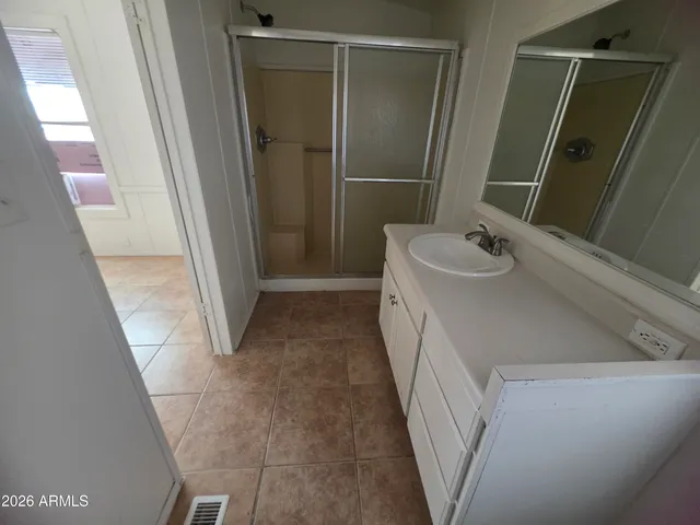 a bathroom with a sink and mirror with toilet