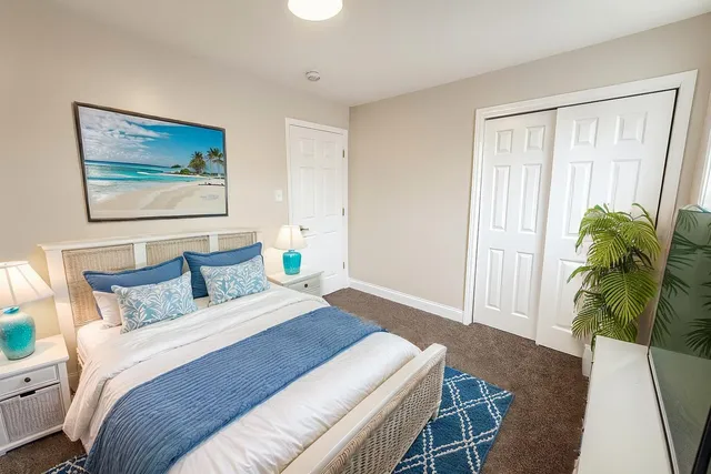 a bedroom with a bed plant and a window