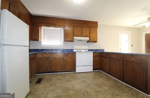 a kitchen with sink a microwave a stove and refrigerator