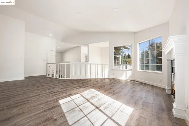a view of wooden floor and windows in a room