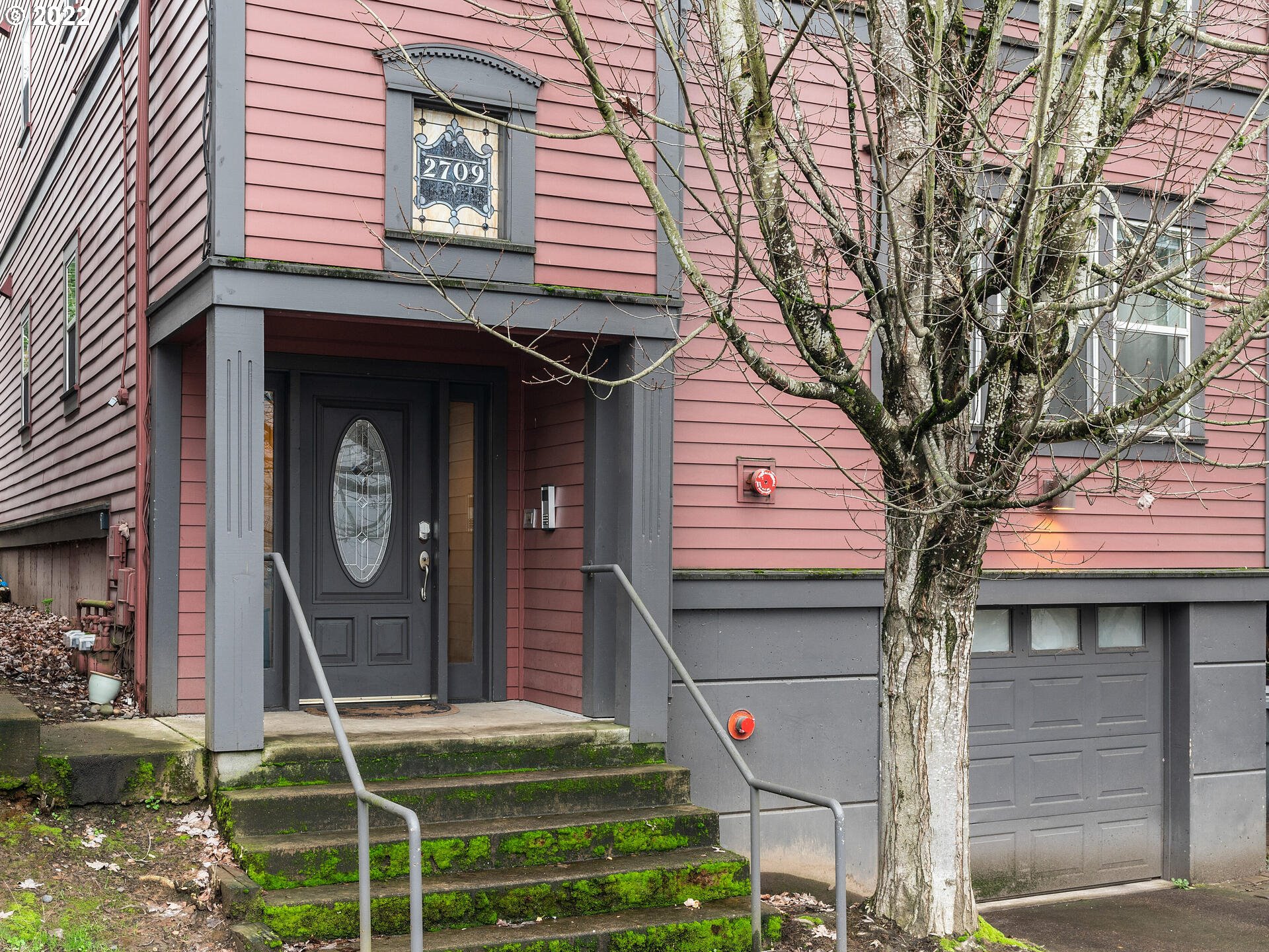 2709 Southwest 2nd Avenue, Unit 101 Portland, OR 97201 - Photo 3 of 25 a front view of a house with plants