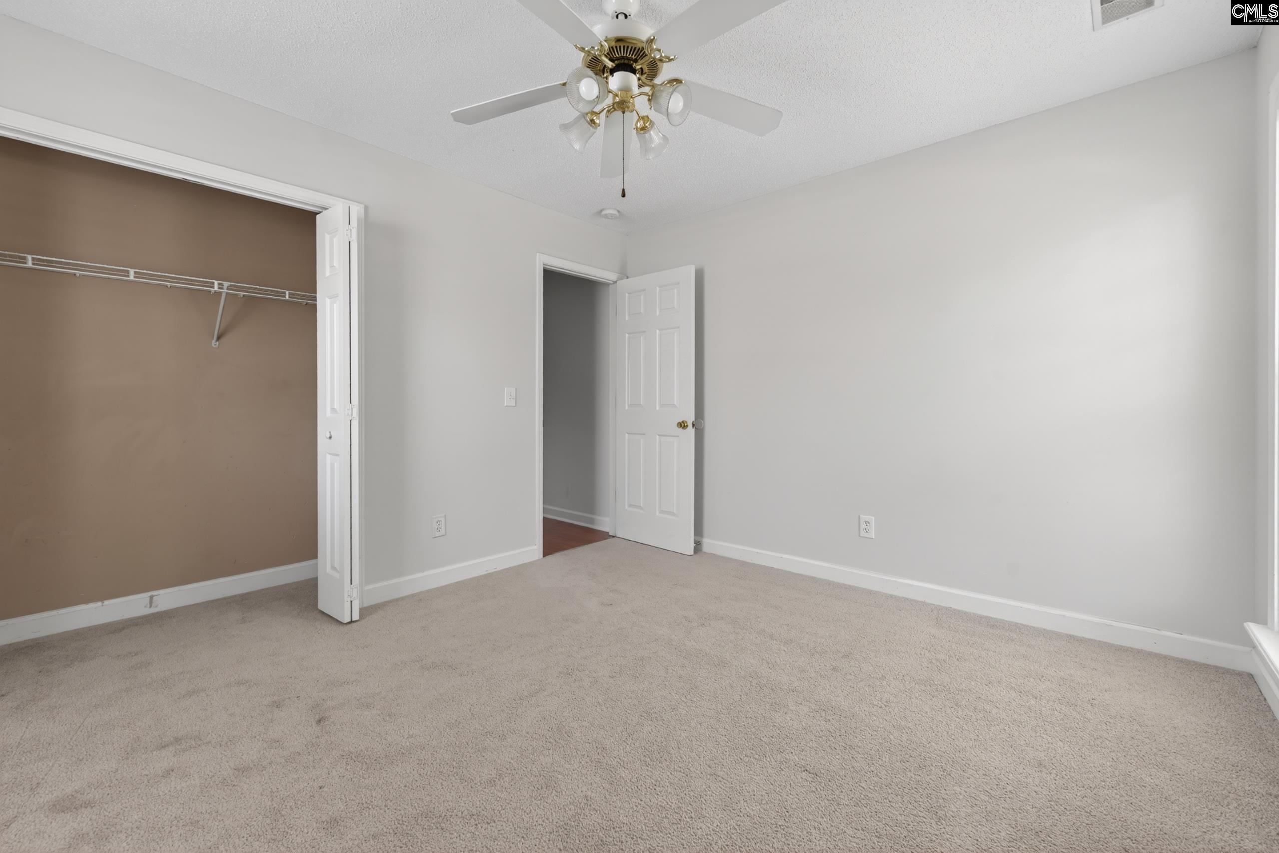 219 Plantation Pointe Drive Elgin, SC 29045 - Photo 23 of 56 an empty room with a chandelier fan