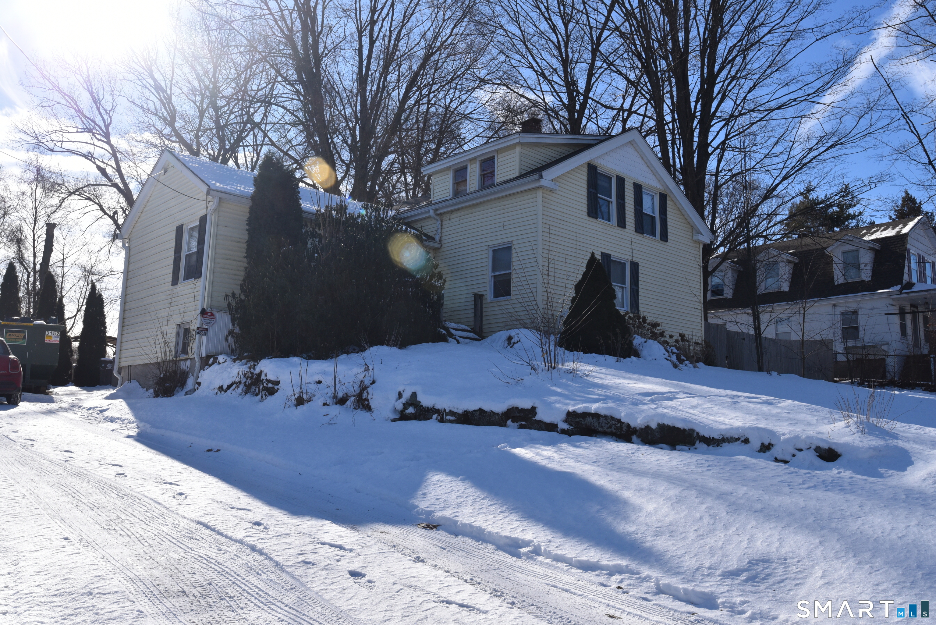 a view of a house with a yard covered in snow