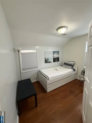 a spacious bedroom with a bed and cabinet
