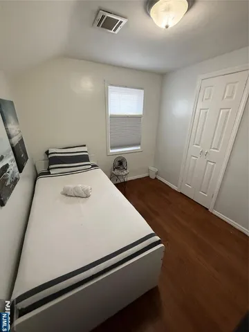 a bedroom with bed and window