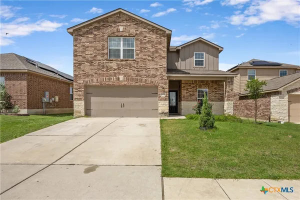 a front view of a house with a yard