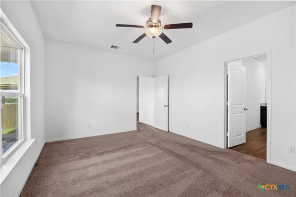 a view of room with hardwood floor and ceiling fan