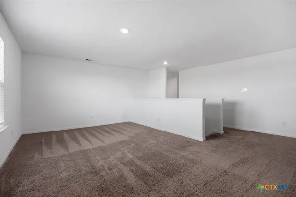 an empty room with a empty space and windows