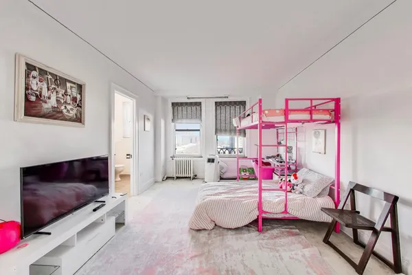 a bedroom with furniture and a flat screen tv