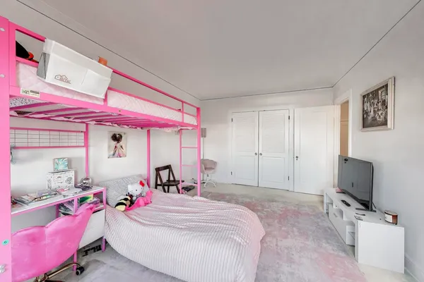a bed room with a bed and a flat screen tv