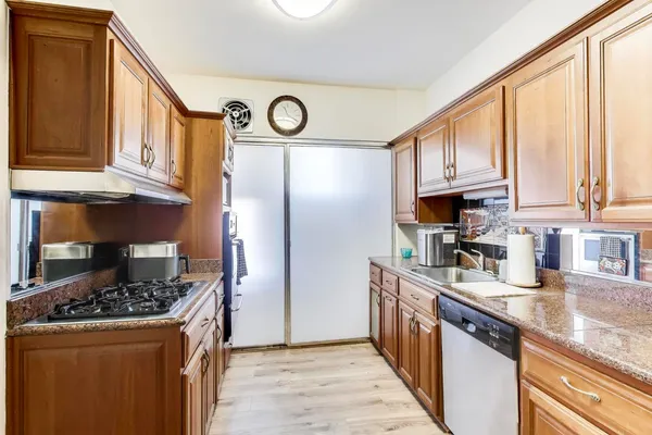 a kitchen with stainless steel appliances granite countertop a stove and a refrigerator