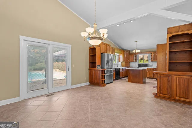 a kitchen with stainless steel appliances granite countertop a sink a stove and refrigerator