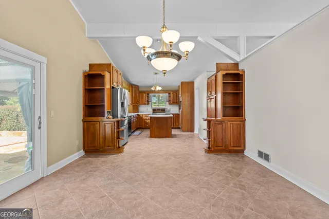 a kitchen with a sink appliances and cabinets