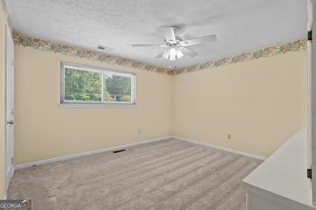a bathroom with a granite countertop sink toilet and a mirror