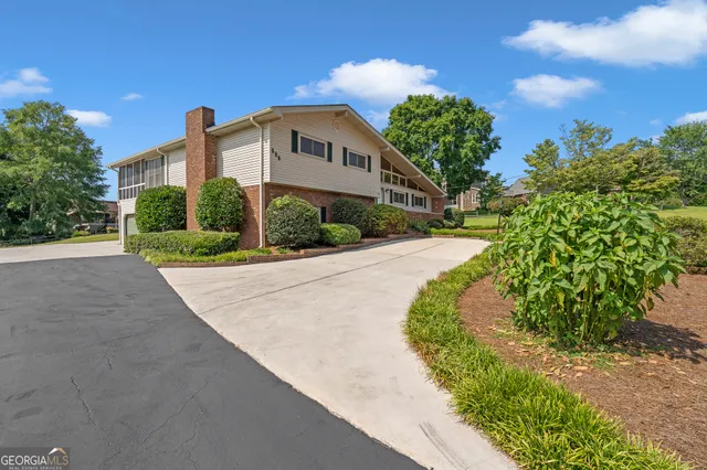 a view of a street with a big yard