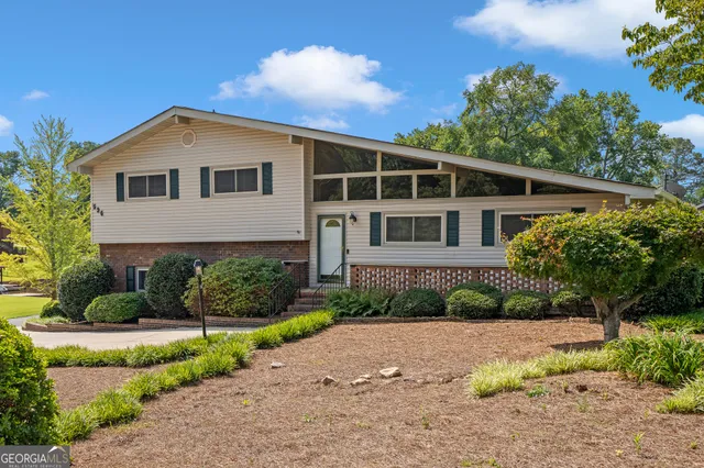 a front view of a house with a garden
