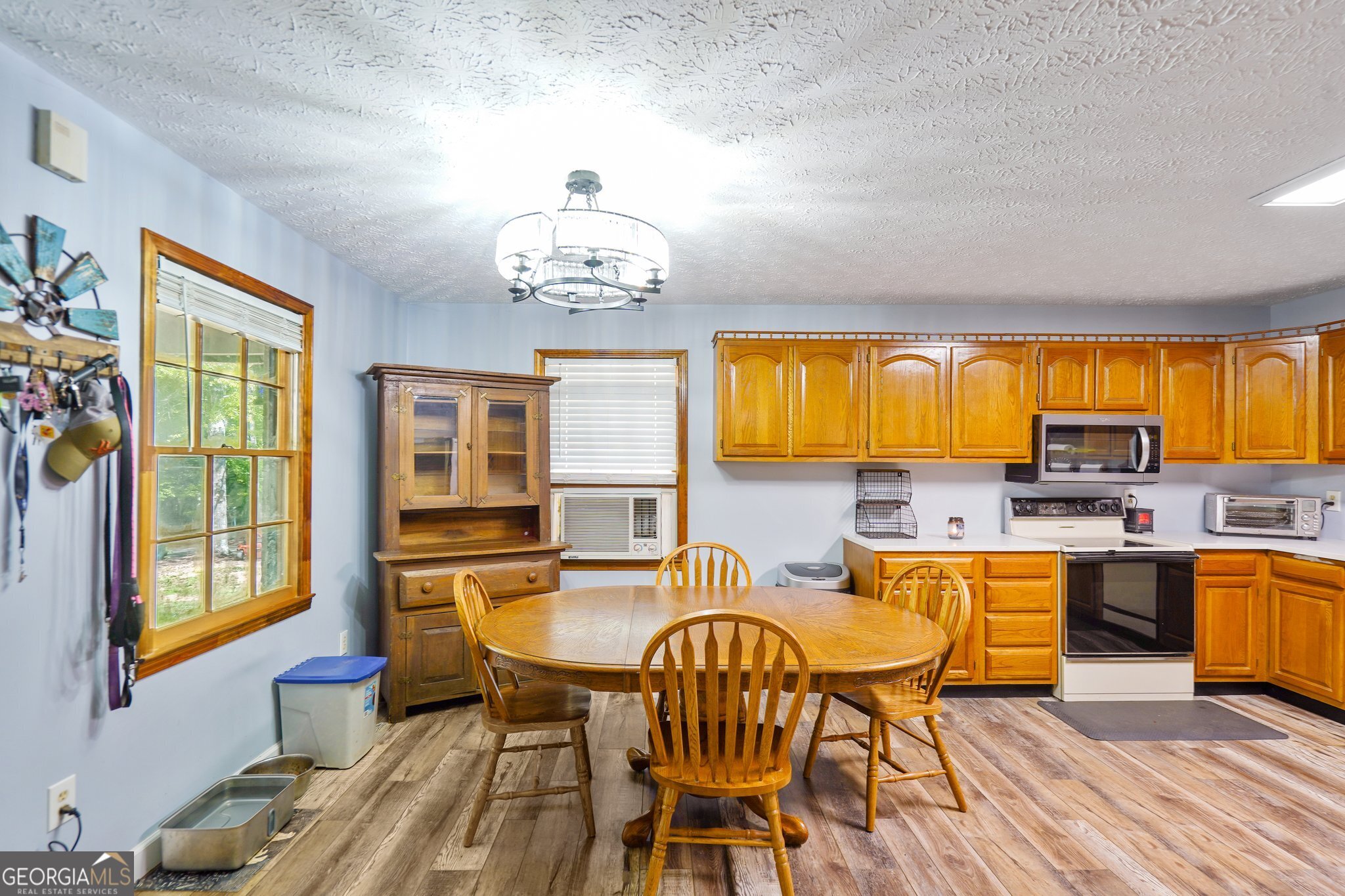 241 Busbin Road Fayetteville, GA 30215 - Photo 12 of 45 a view of a dining room with furniture a chandelier and wooden floor