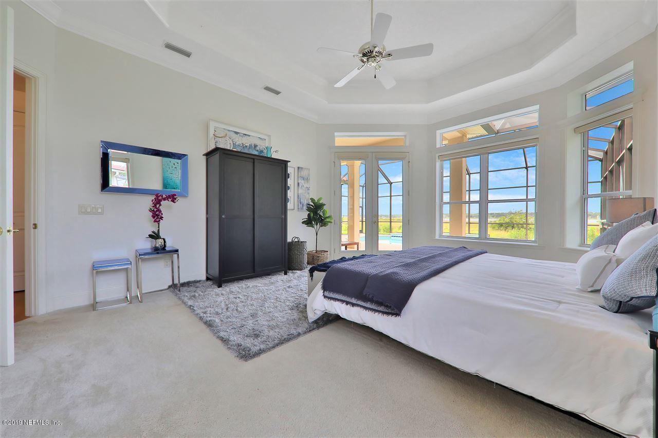 320 View Point Place St. Augustine, FL 32080 - Photo 3 of 33 a spacious bedroom with a bed a dresser and a large window