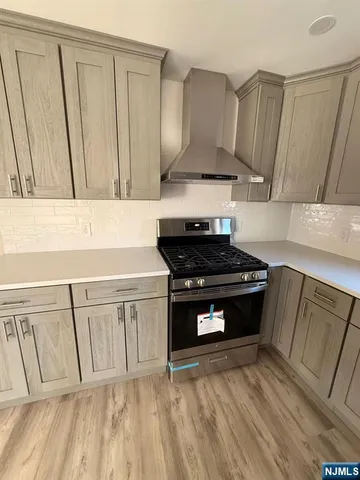 a kitchen with a sink and wooden floor