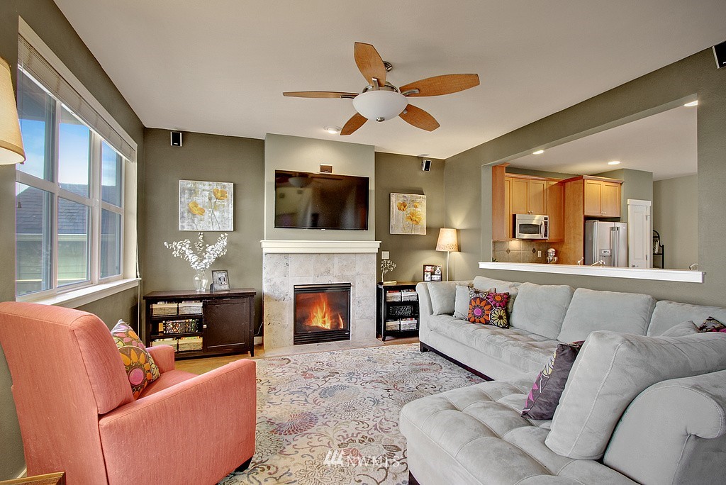559 Alpine Ridge Place Northwest Issaquah, WA 98027 - Photo 2 of 15 a living room with furniture a fireplace and a flat screen tv