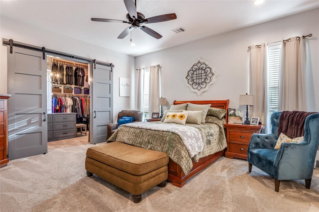 216 Deer Glade Court Azle, TX 76020 - Photo 19 of 40 a bedroom with a bed couch and a window