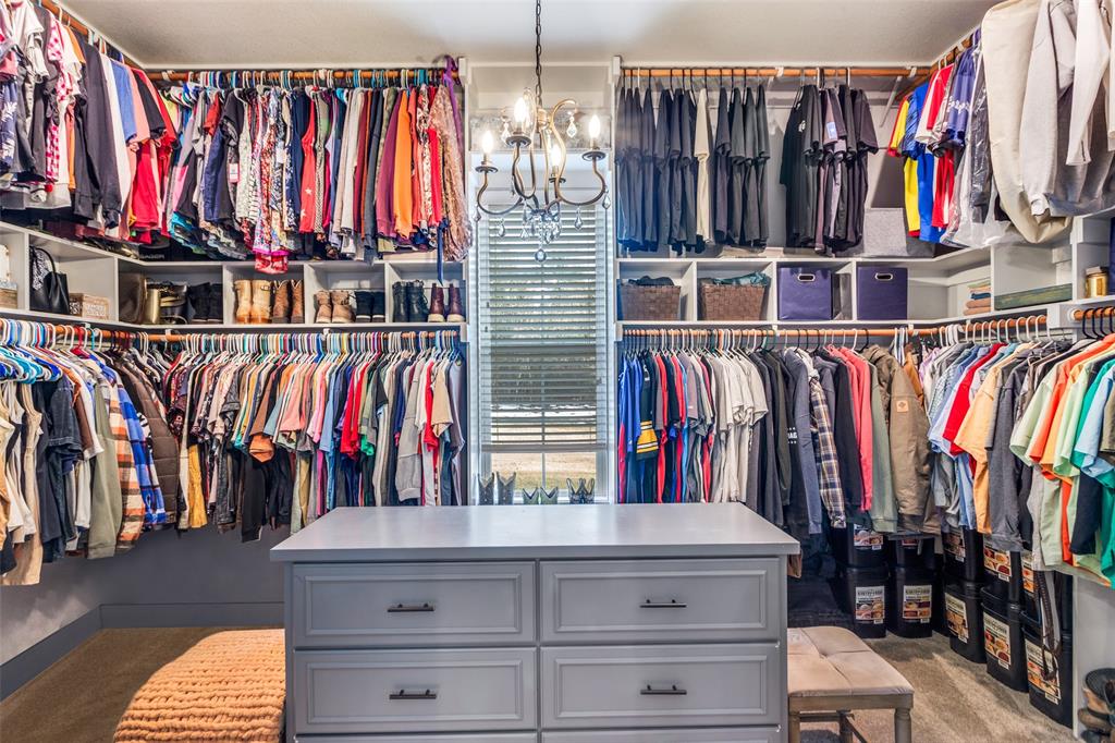 216 Deer Glade Court Azle, TX 76020 - Photo 20 of 40 a view of walk in closet with clothes and shoes